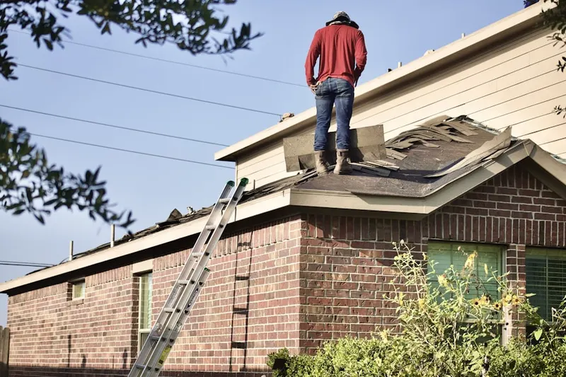 Professional roofer working on a residential roof in Jacobsville